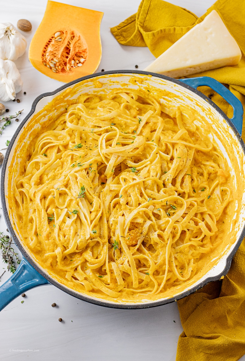 big pan filled with fettuccine pasta in a butternut squash sauce