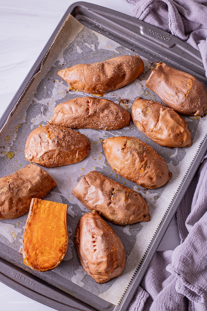 sweet potato halves on a baking sheet