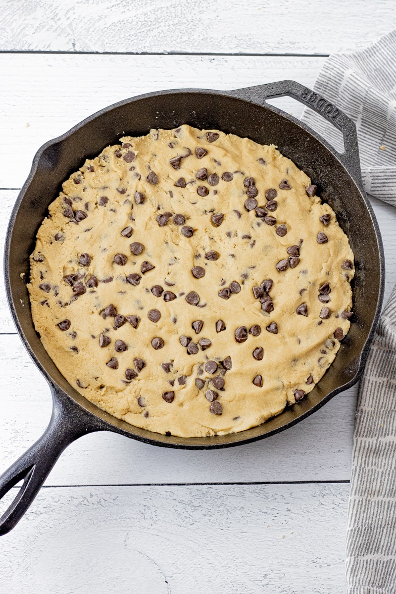 cookie dough pressed into a cast iron skillet