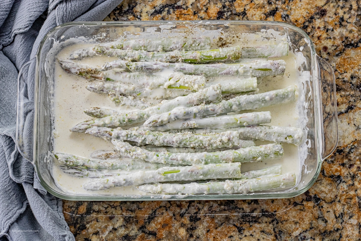 asparagus spears in a cream sauce in a baking dish