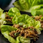 ground chicken lettuce wraps on a black plate