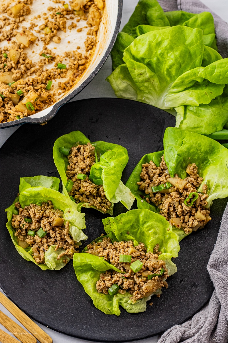 ground chicken lettuce wraps on a black serving plate