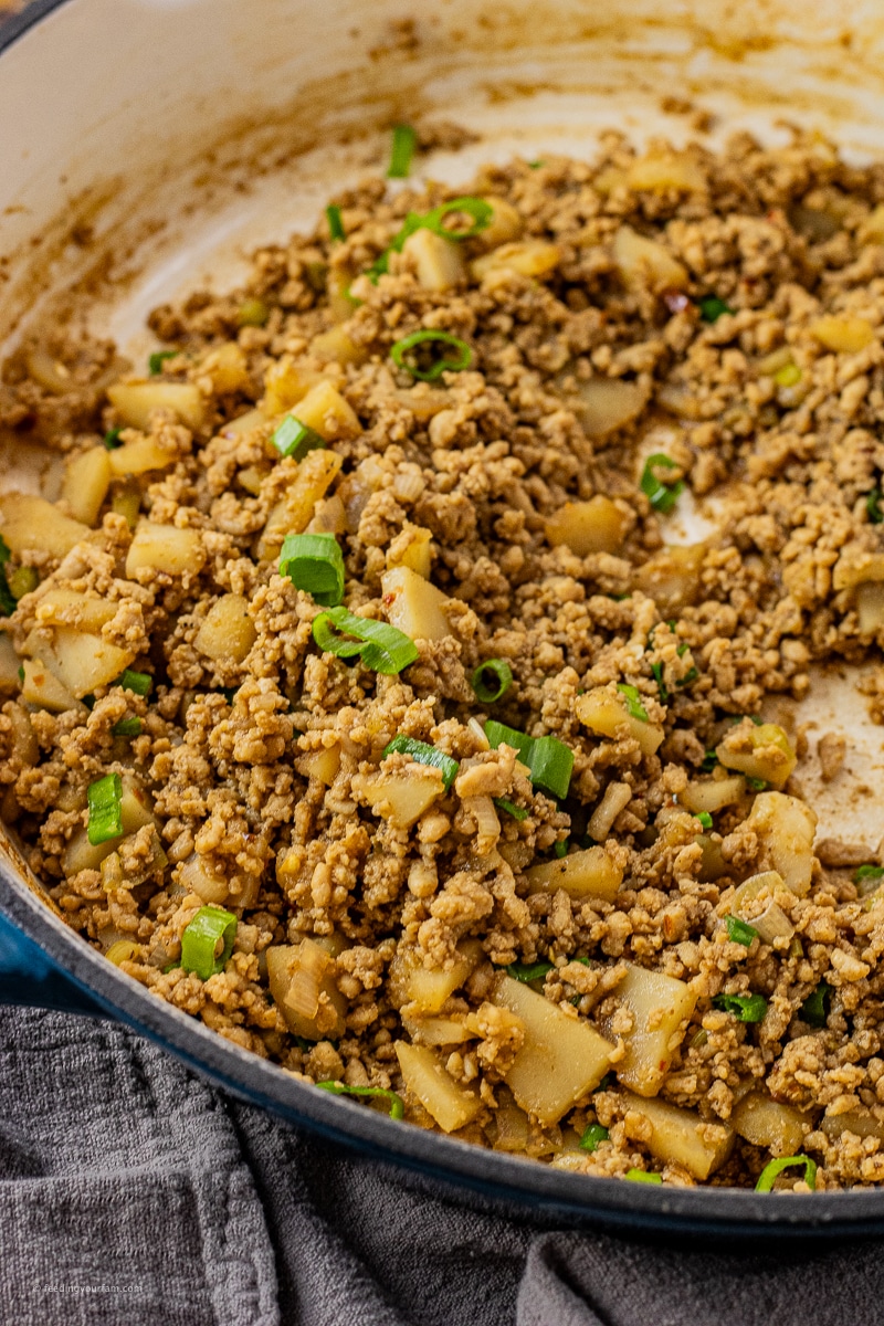 ground chicken with water chestnuts and green onions in a big skillet