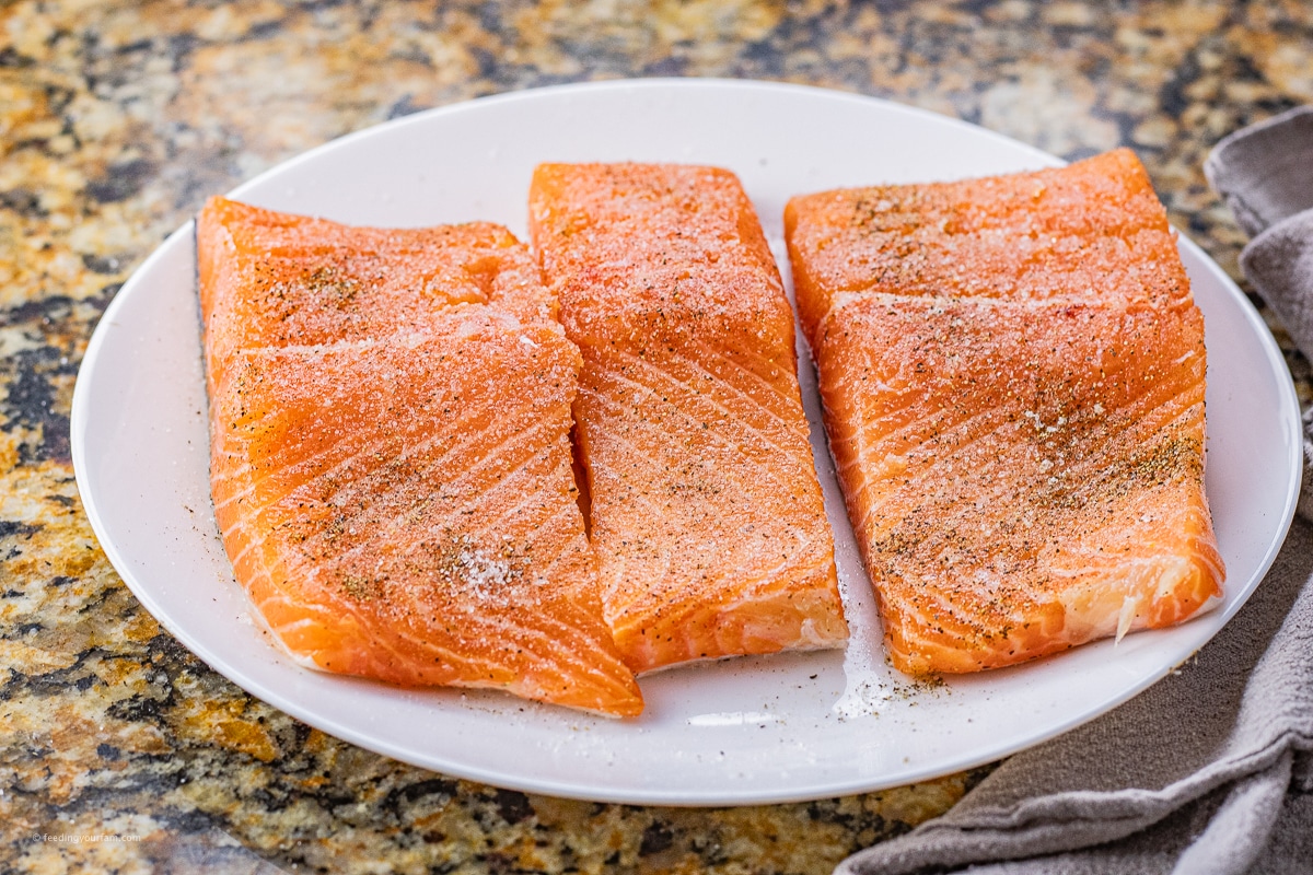 seasoned, uncooked salmon on a plate