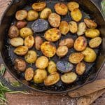 small potatoes, sliced in half and cooked in a cast iron skillet