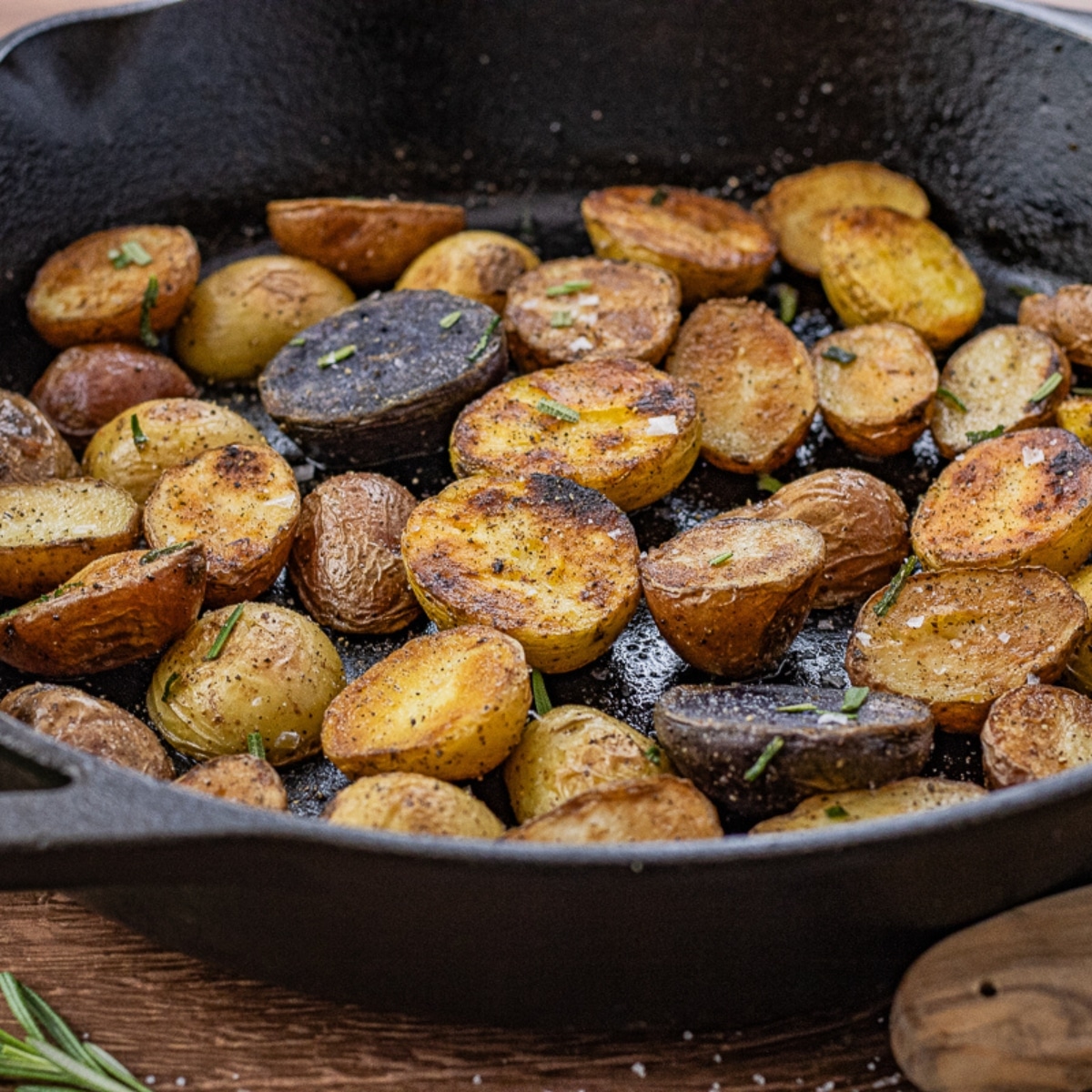 small potatoes, sliced in halves cooked in a cast iron pan