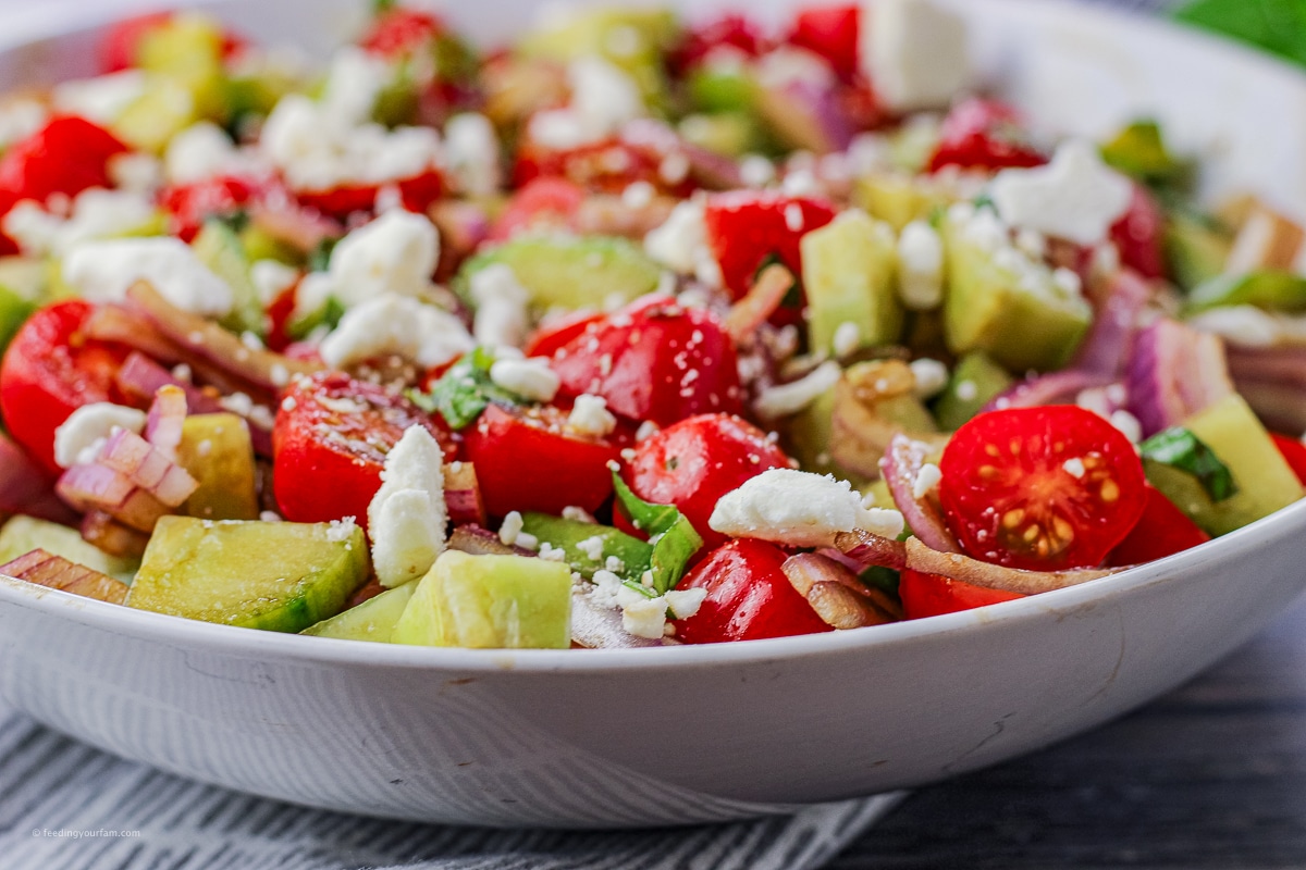 salad made with tomatoes, cucumber and red tomatoes with feta cheese and balsamic dressing