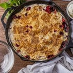 dump cake made with cherry pie filling and crushed pineapples cooked in a cast iron skillet