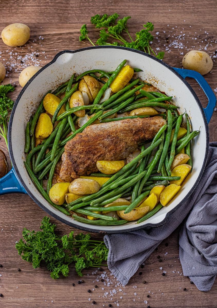 Tender pork tenderloin is cooked perfectly in a cast iron pan with potatoes and green beans to make an easy dinner and one-pan meal. This pork tenderloin comes out juicy and delicious every time. pork tenderloin recipe | cast iron pork tenderloin | roast pork tenderloin | oven baked pork tenderloin