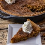 sliced piece of snickerdoodle skillet cookie on a white square plate