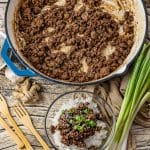 large cast iron skillet with ground beef cooked inside