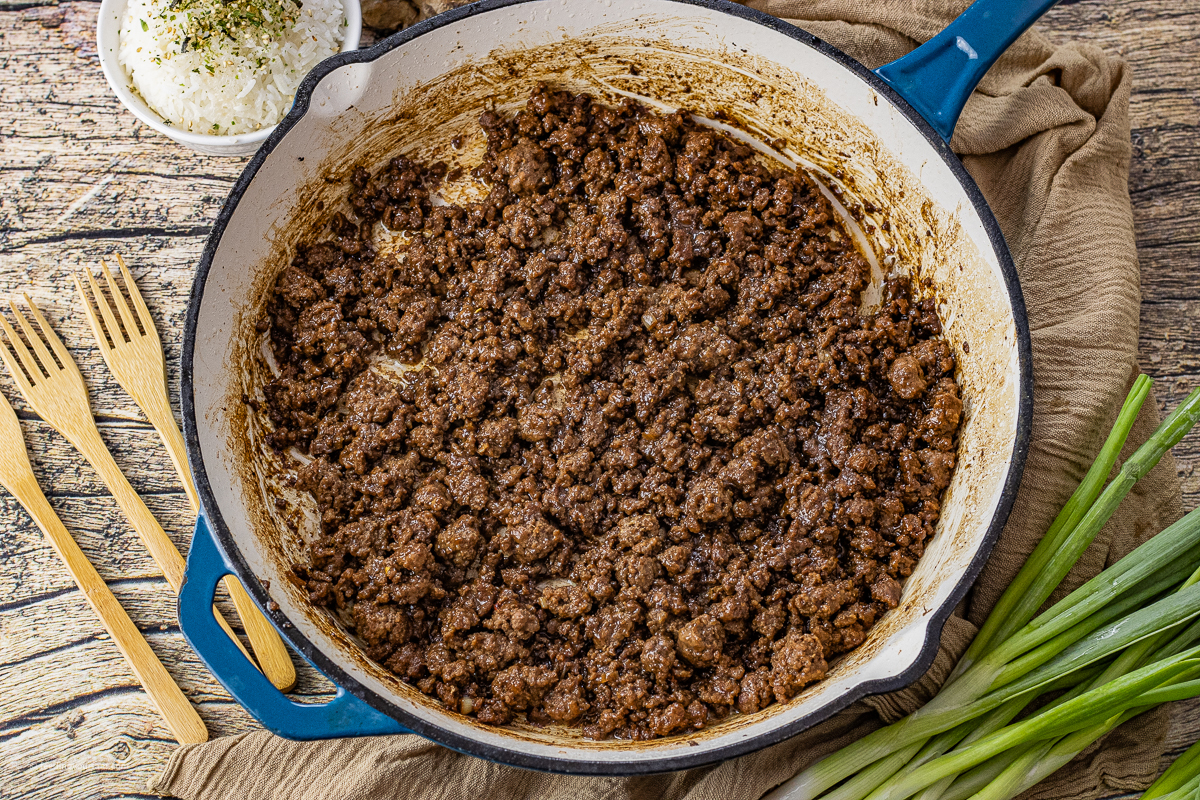 ground beef in a soy sauce sauce cooked in an enameled cast iron pan