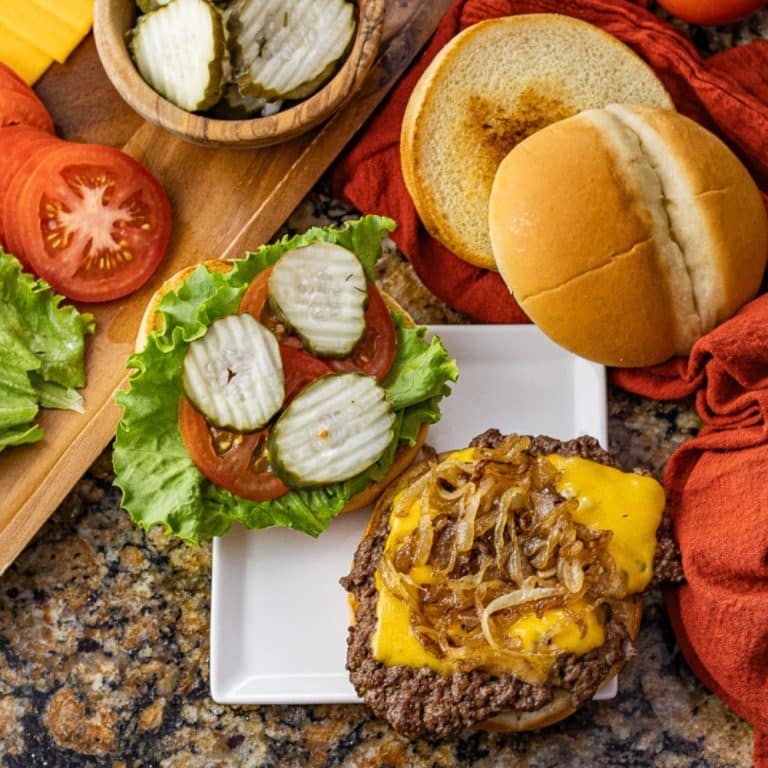 cheeseburger opened on a toasted bun topped with grilled onions