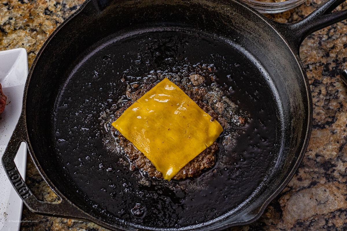 smashed burger topped with melted cheese