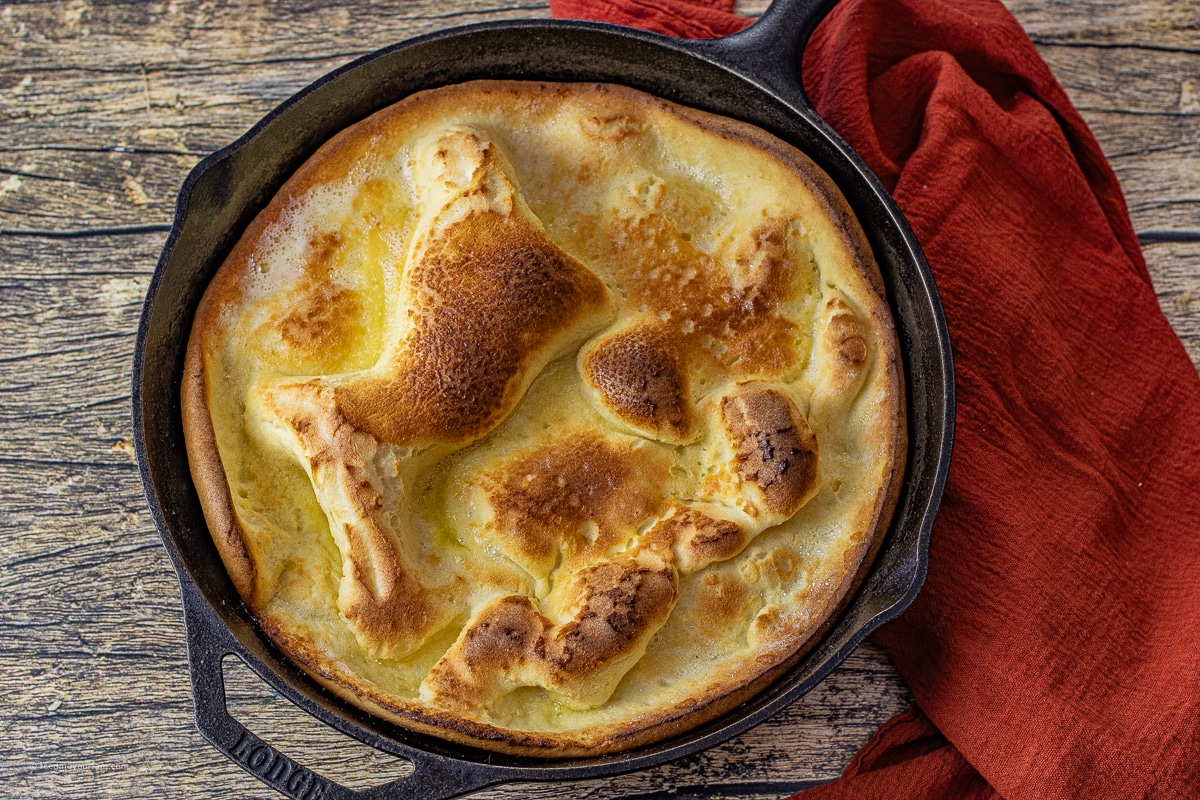 puffy dutch oven pancake in a cast iron skillet