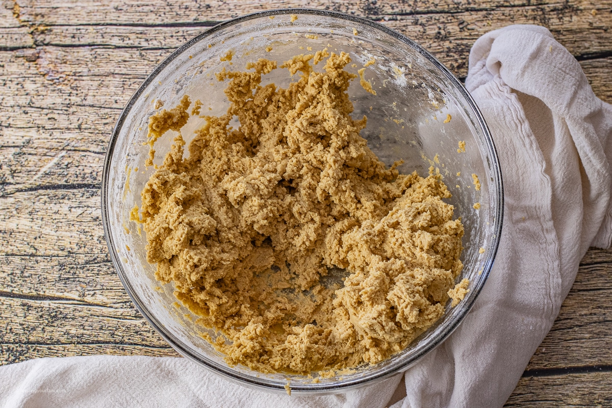 peanut butter cookie dough in a large glass mixing bowl