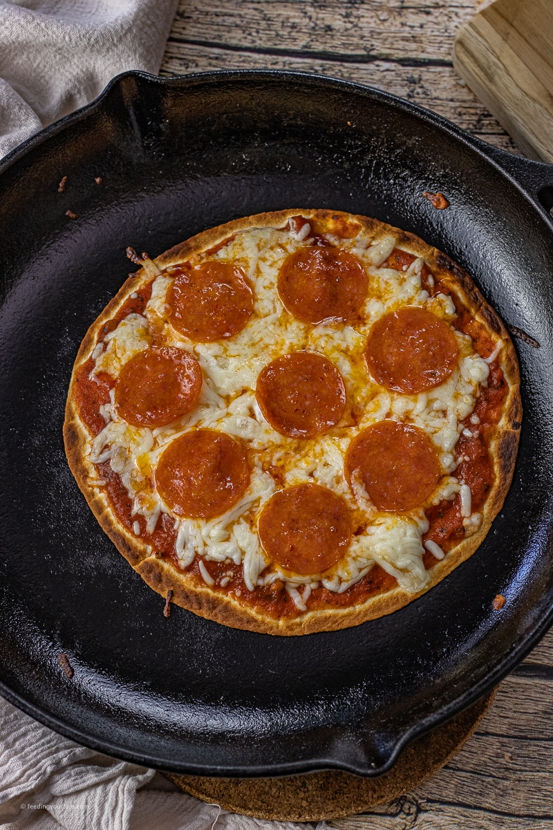 Cast iron skillet tortilla pizza is perfect for a busy weeknight meal or a quick and easy lunch. With a perfectly crispy tortilla crust, melted cheese, and topped with your favorite toppings, this pizza recipe comes together quick.