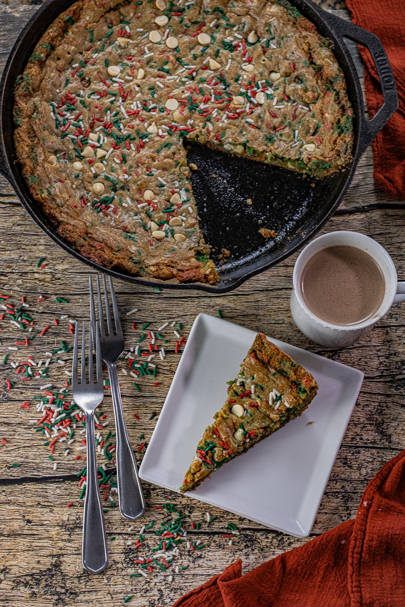 Make the Holidays unforgettable with a giant Cast Iron Skillet Christmas Sprinkle Cookie. Soft, chewy and packed with all classic sugar cookie flavor you love, and bursting with festive colorful sprinkles. Easy to make and perfect for sharing, this is sure to bring all the smiles