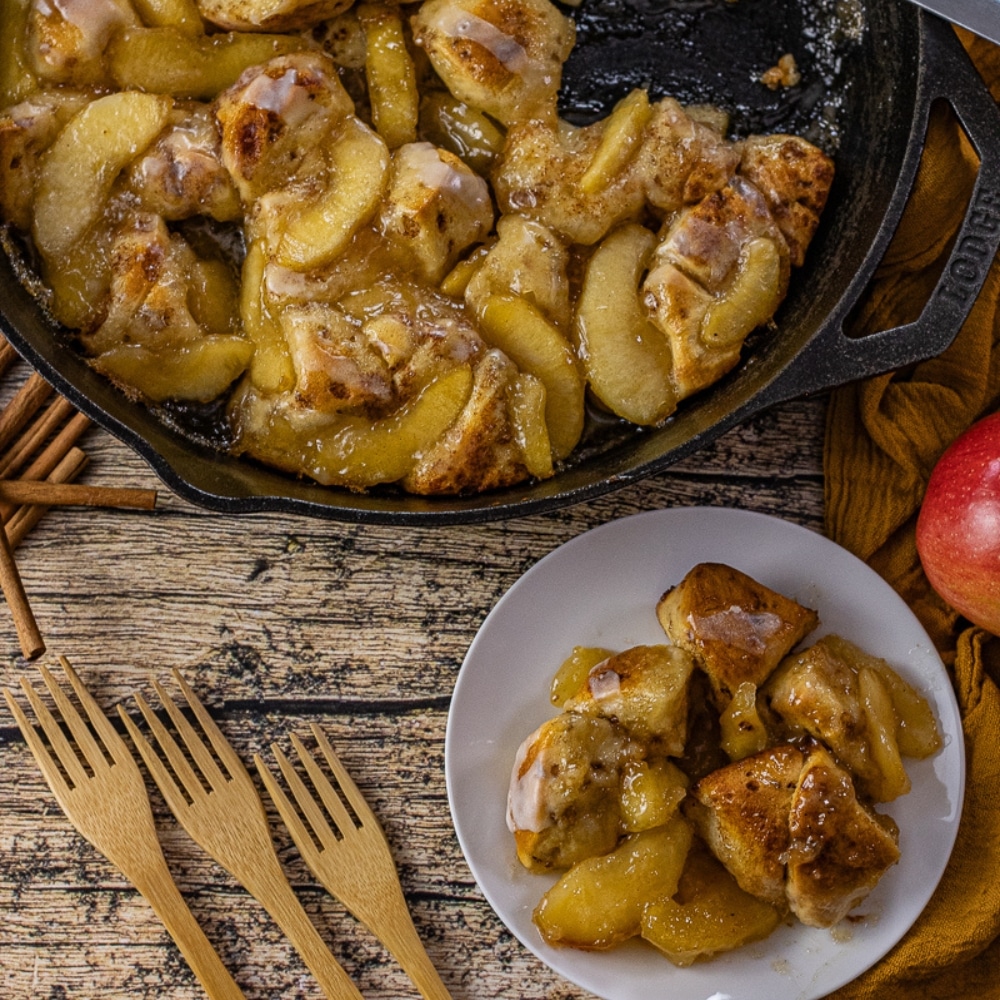 cinnamon rolls with apple pie filling in a cast iron skillet