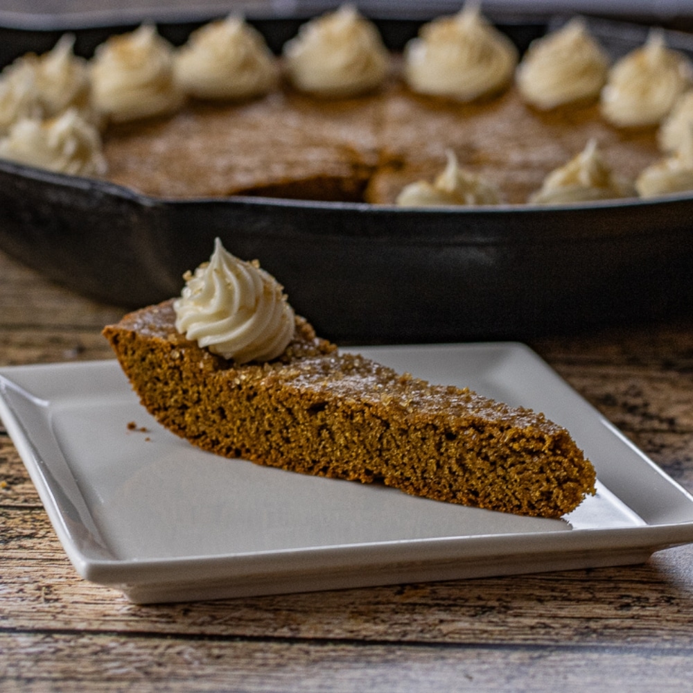 slice of gingerbread cookie topped with a dollop of cream cheese frosting