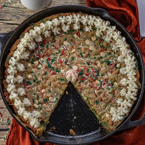 cast iron skillet with a Christmas sprinkle cookie baked in it