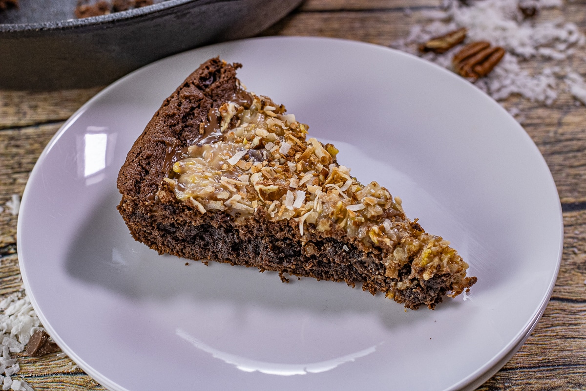 slice of German chocolate cookie made in a cast iron skillet