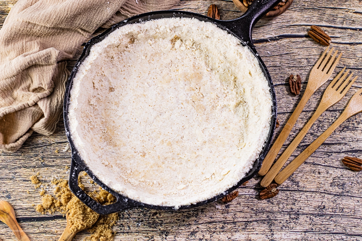 unbaked shortbread crust in a cast iron skillet