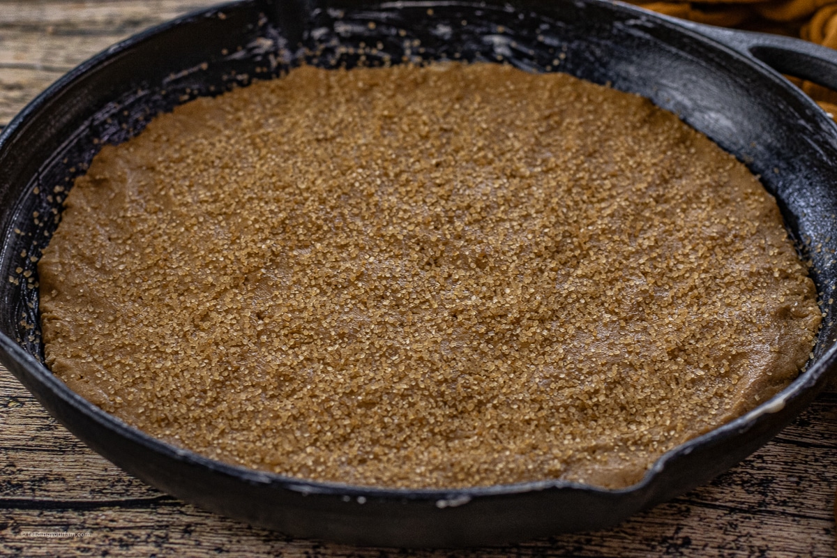 gingerbread cookie dough pressed in a cast iron skillet