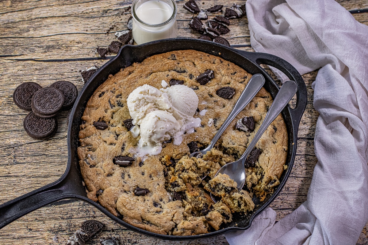 cookies and cream cake cookie made in a cast iron skillet topped with ice cream