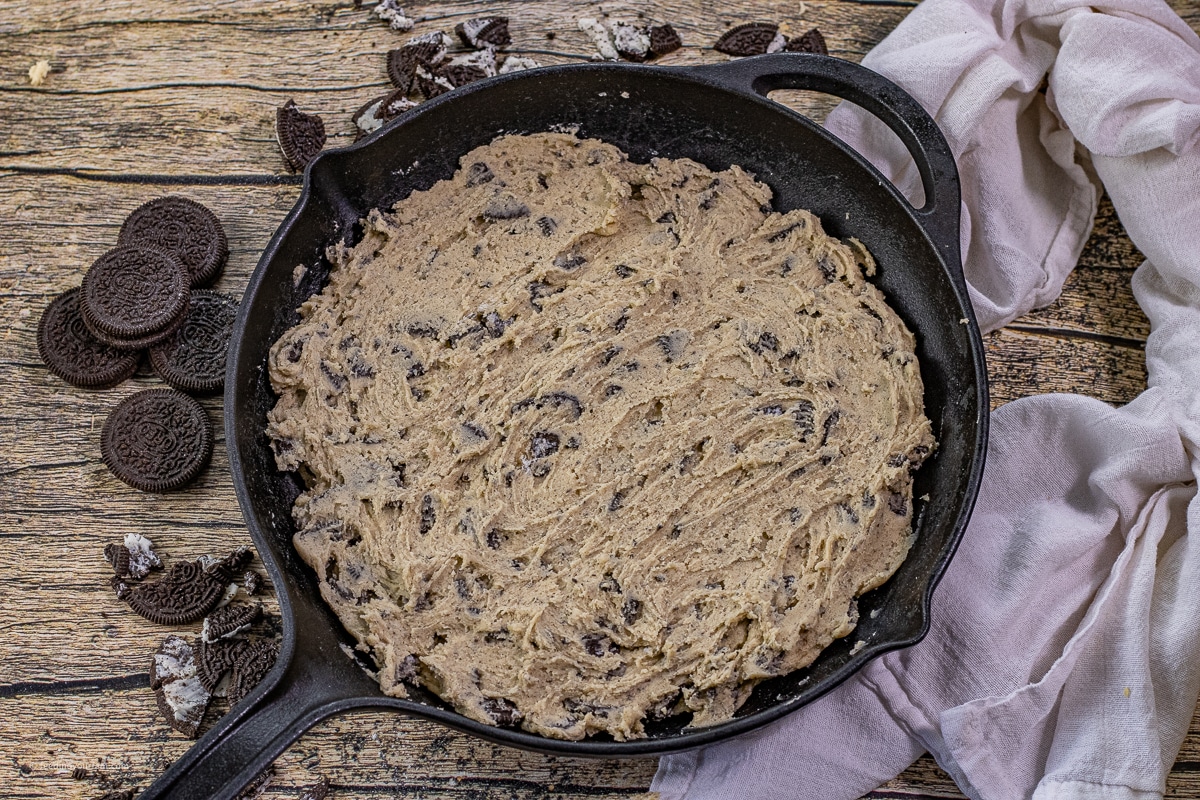 uncooked cookies and cream cookie dough in a cast iron skillet 