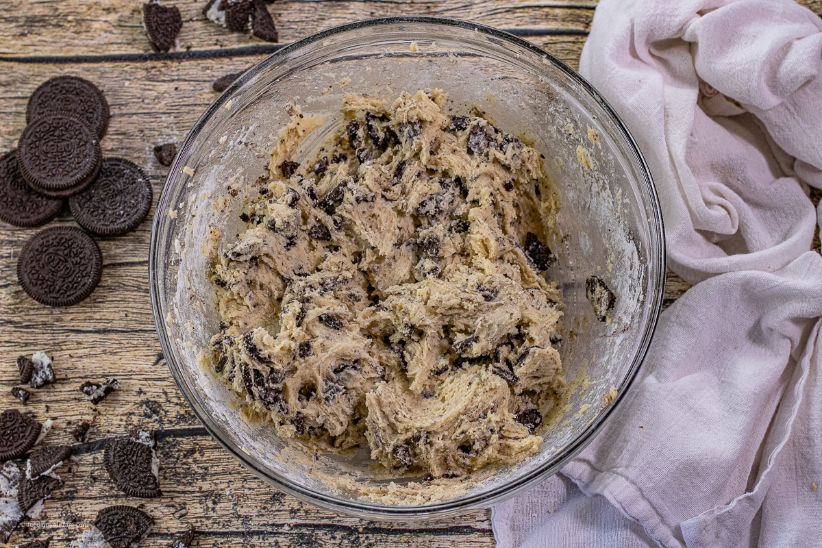 cookies and cream cookie dough in a glass mixing bowl