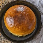 large round loaf of white bread in a cast iron skillet