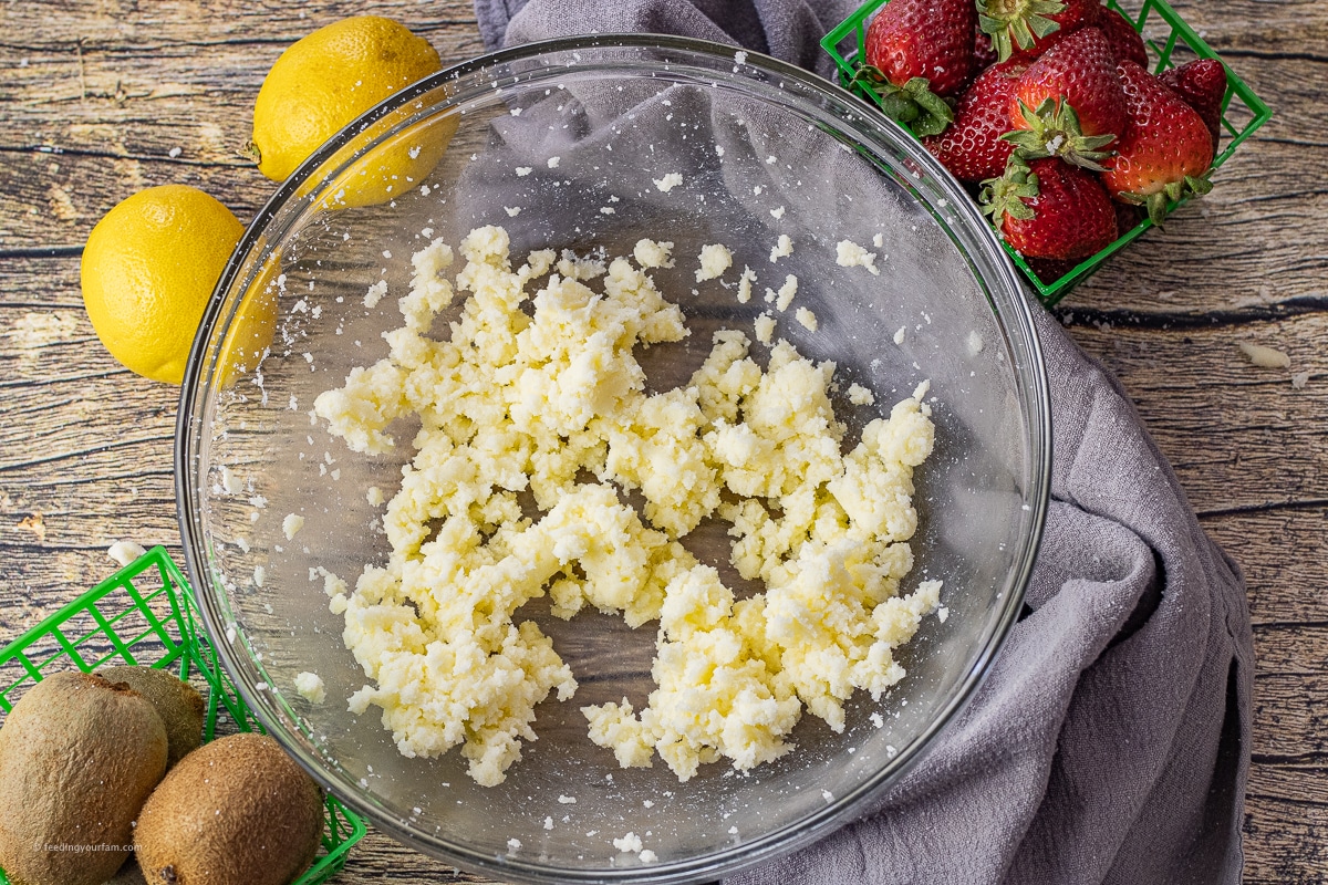 butter and sugar mixed together in a glass mixing bowl