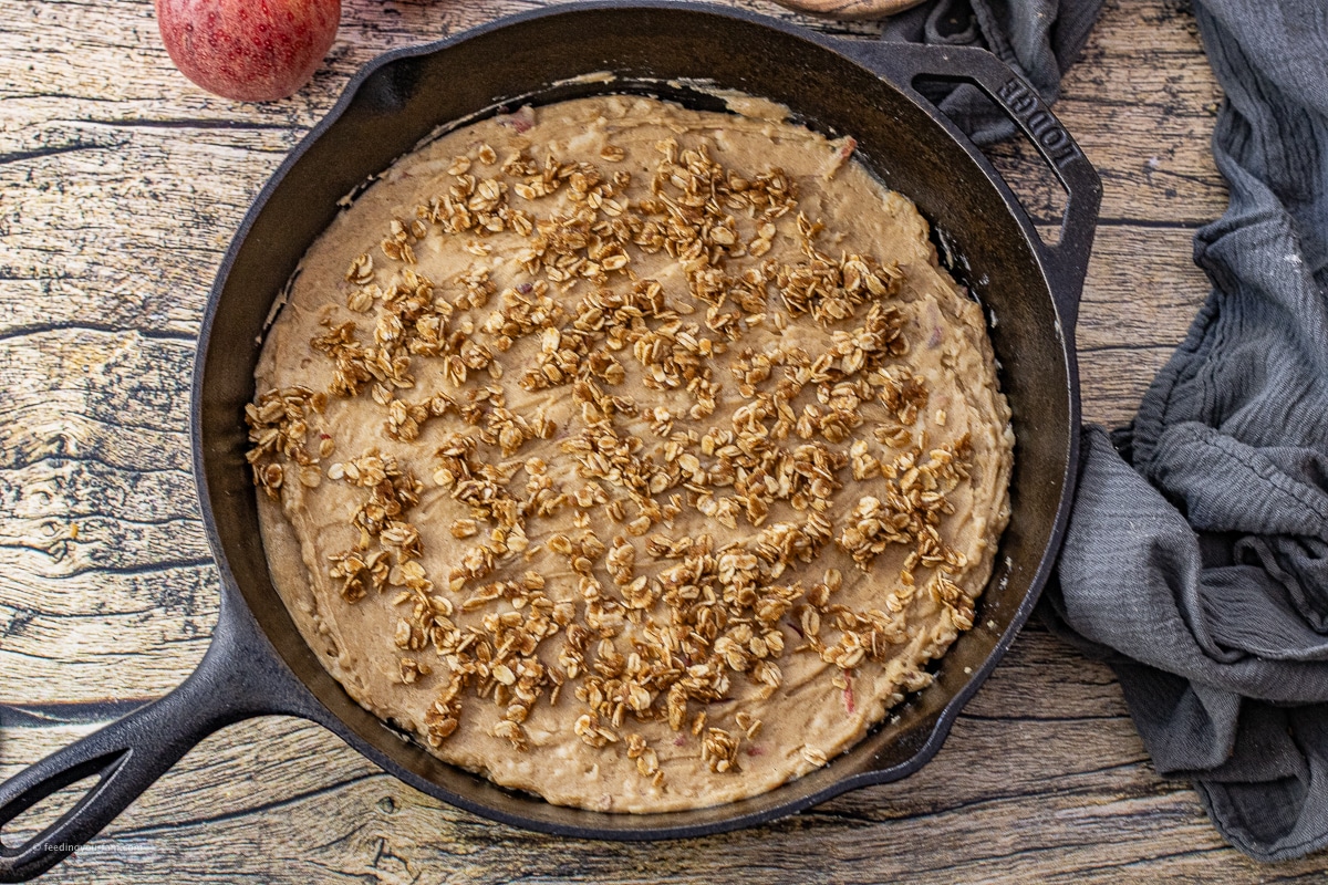 uncooked apple cake in a cast iron skillet