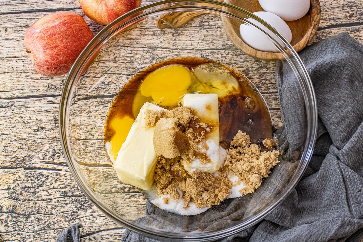 butter, sugars, vanilla, and eggs in a glass mixing bowl