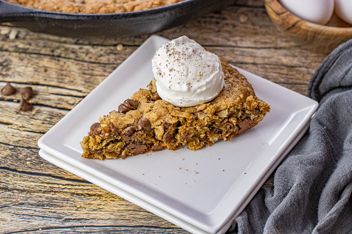 slice of oatmeal chocolate chip skillet cookie on a plate