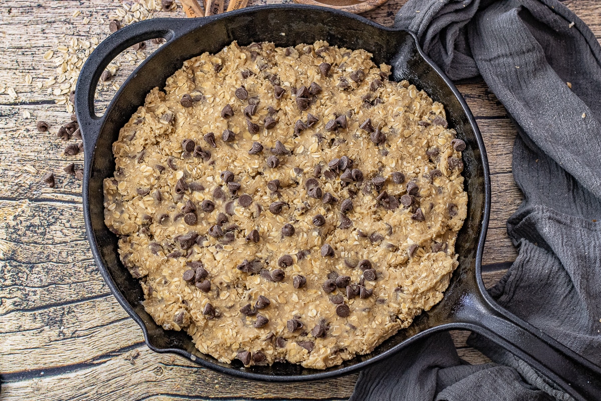 chocolate chip cookie dough in a cast iron skillet