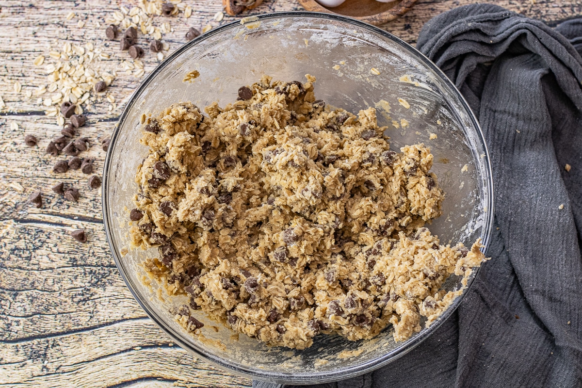 oatmeal chocolate chip cookie dough in a glass mixing bowl