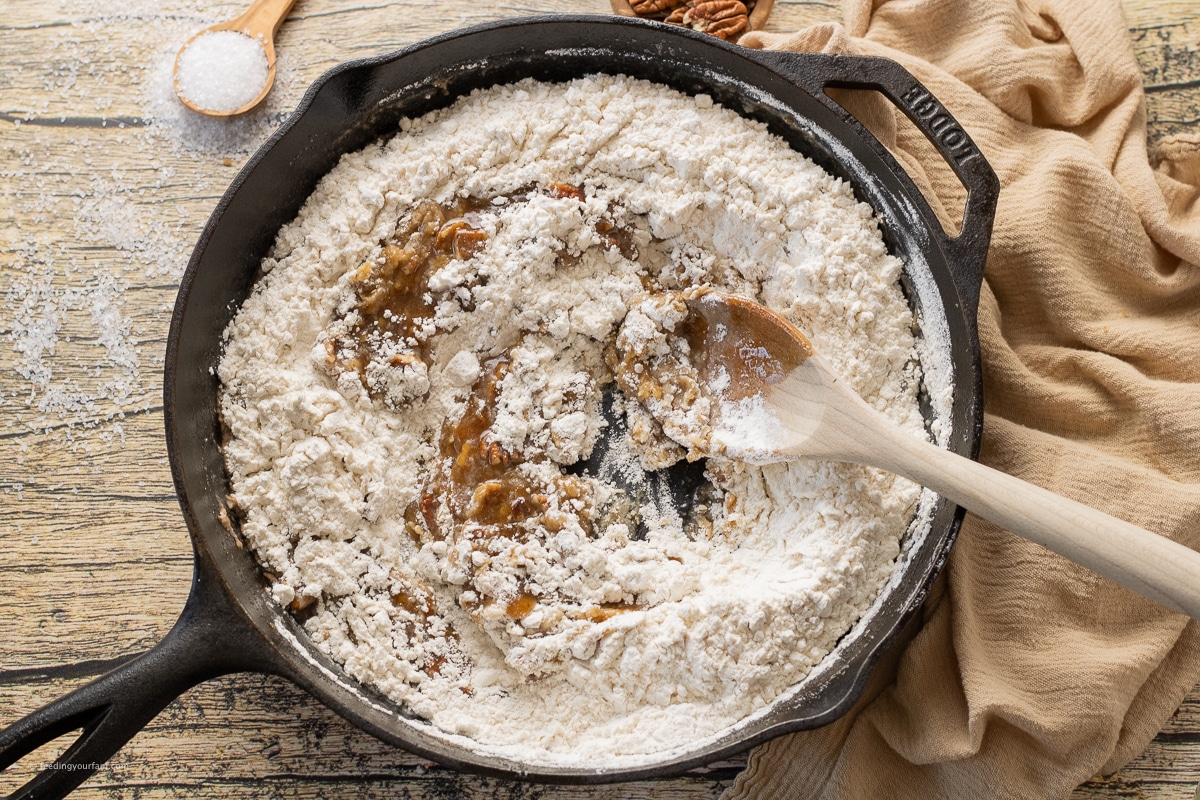 making brown butter pecan cookies dough in a cast iron skillet 