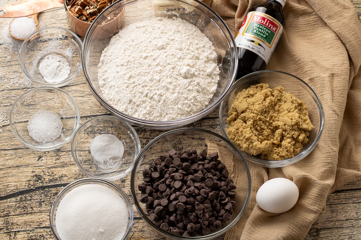 ingredients in glass bowls to make brown butter chocolate chip pecan cookies