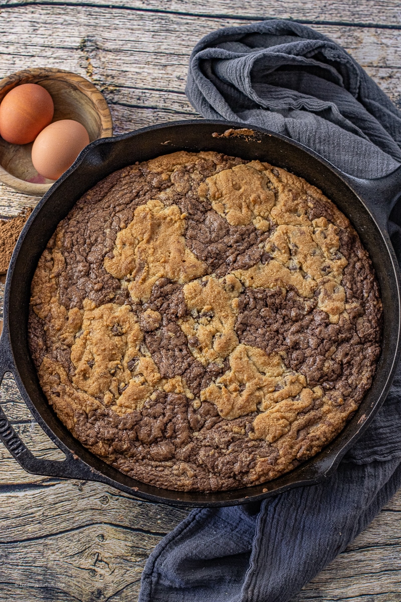 brownie mixed with cookie in a cast iron skillet