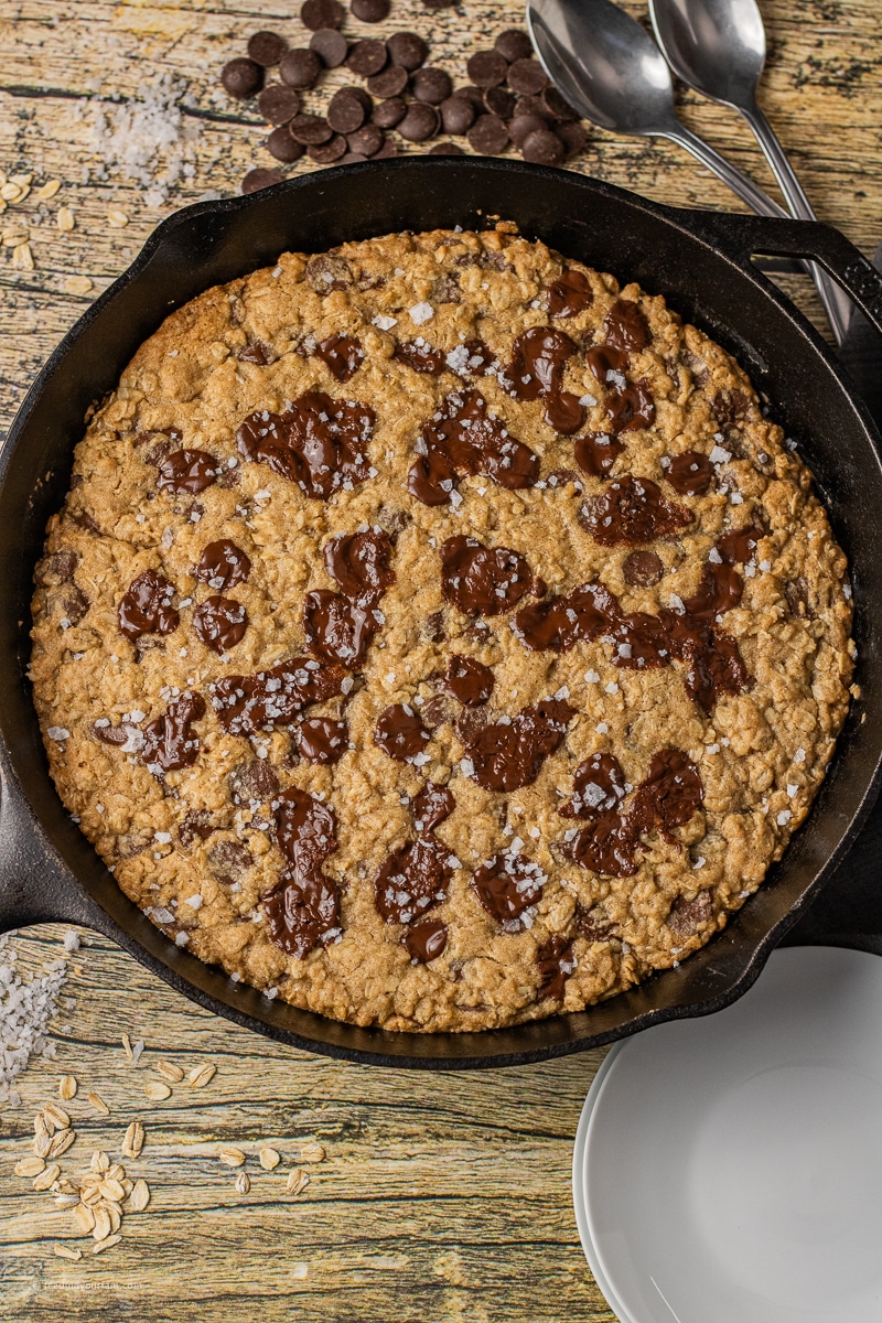 oatmeal skillet cookie with chocolate chips baked in a black cast iron skillet