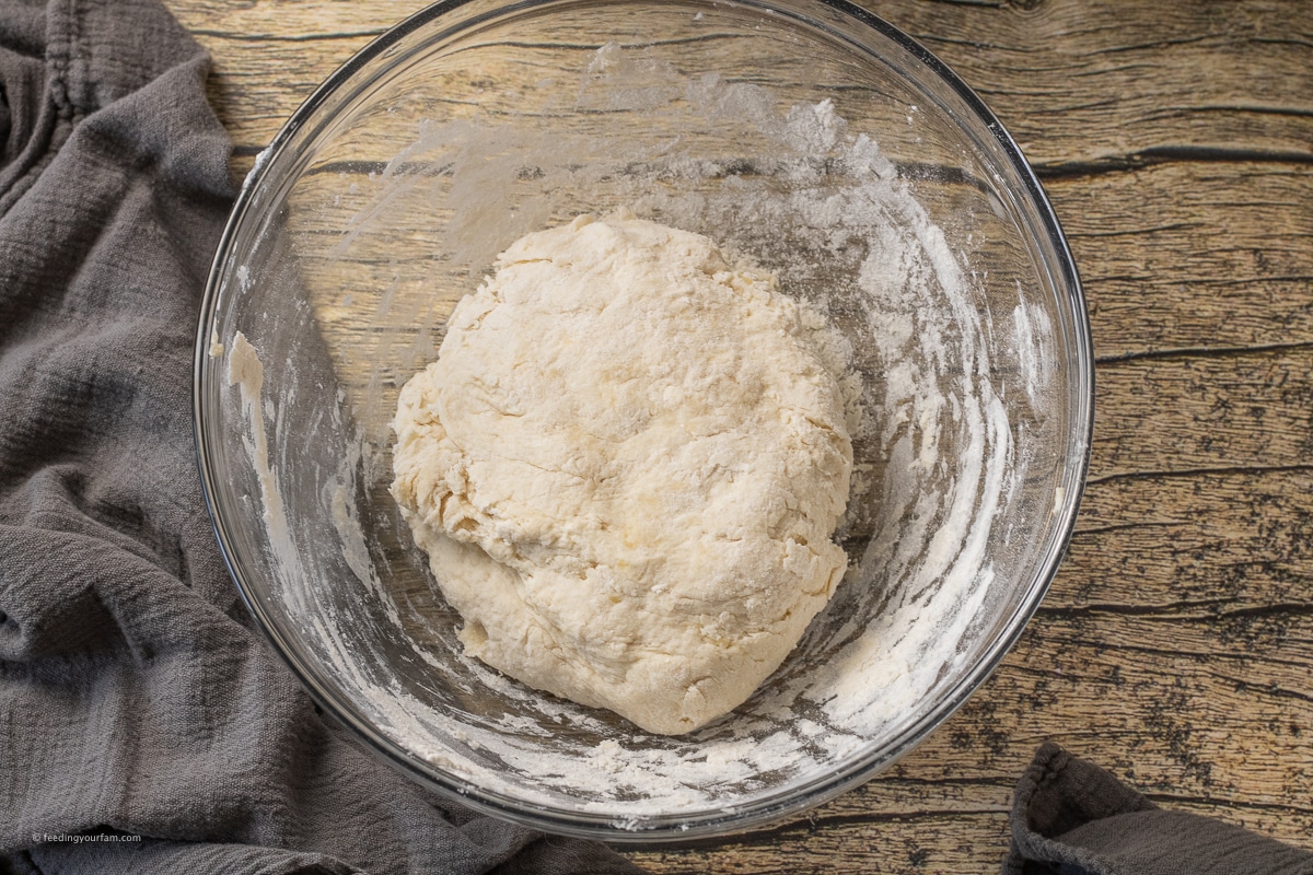 buttermilk biscuit dough in a glass mixing bowl