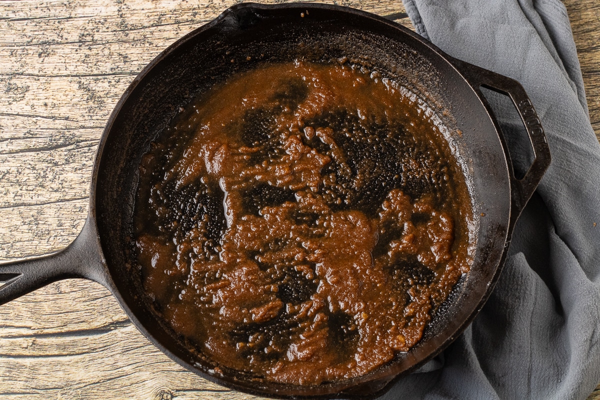 melted butter with brown sugar and spices in a cast iron skillet 