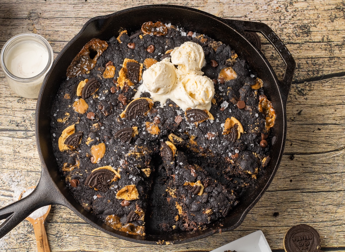 dark black cookie with crushed Oreos, caramel and chocolate topped with ice cream