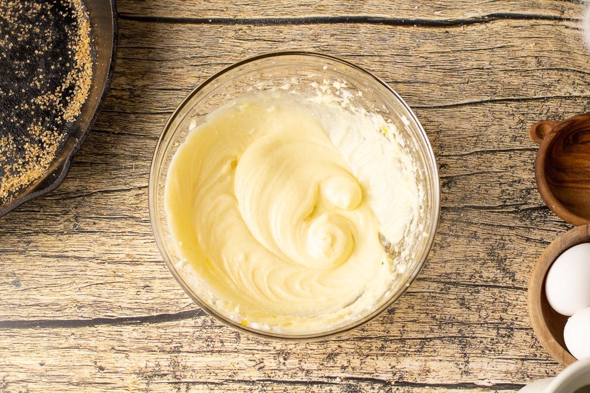 cream cheese and sugar mixed in a mixing bowl