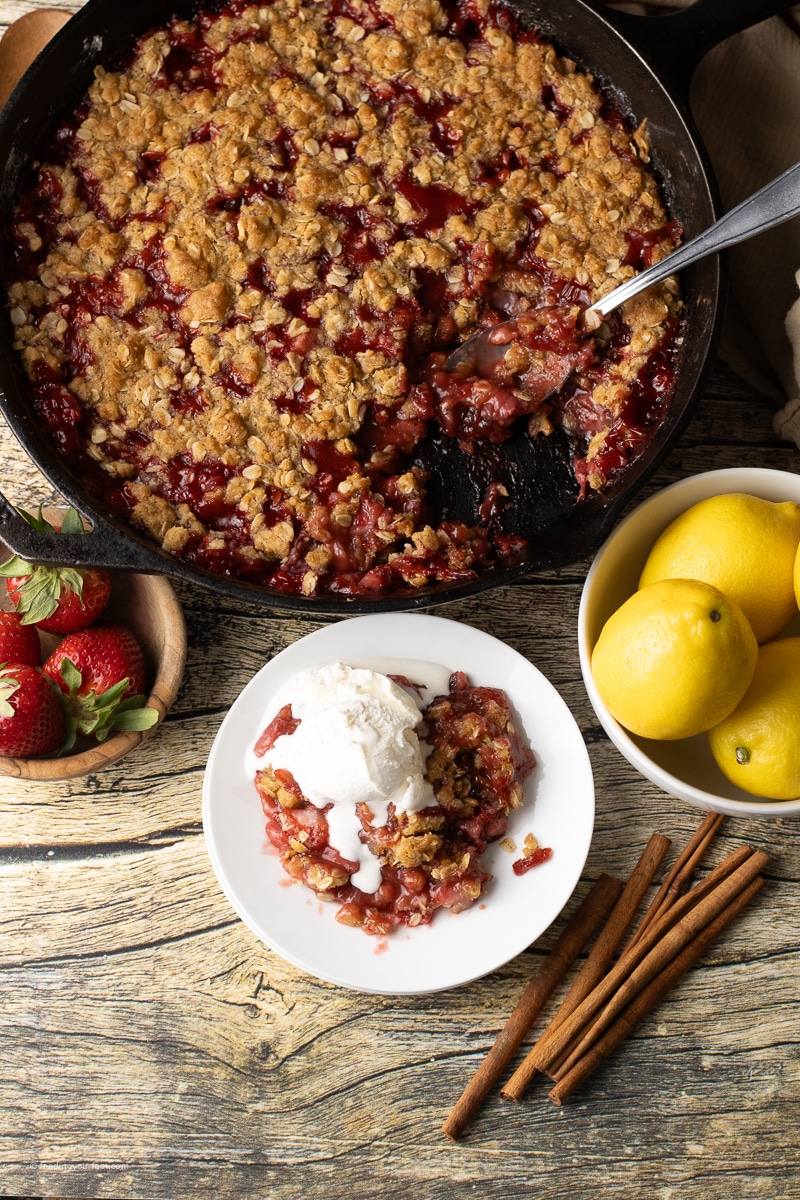 strawberry crisp topped with crisp oatmeal in a cast iron skillet