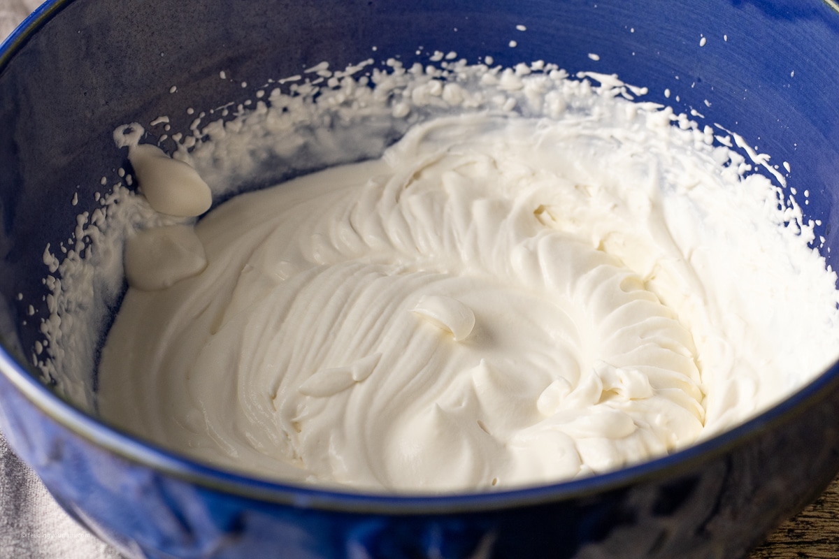 whipped cream in a blue mixing bowl