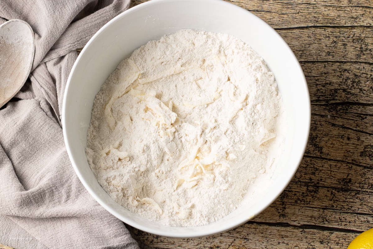 flour with grated butter in a mixing bowl