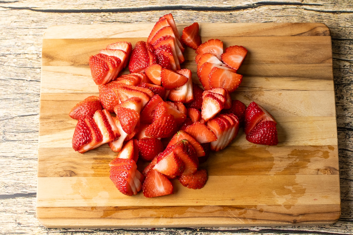 sliced strawberries on a cutting board